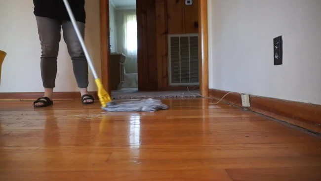Is it safe to clean hardwood floors yourself by removing the carpet