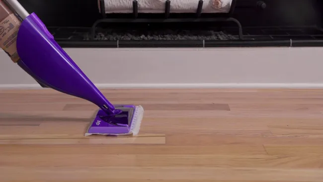 What causes the hardwood floor to be sticky after mopping with Swiffer