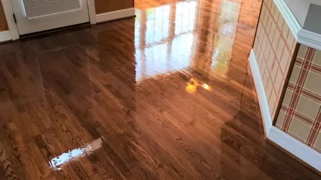 What is the purpose of cleaning your hardwood floor after removing the carpet