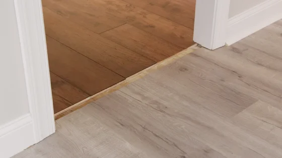 How should I prepare the existing hardwood floor for installation