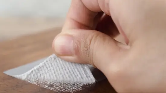 What removes sticky tape residue from wood